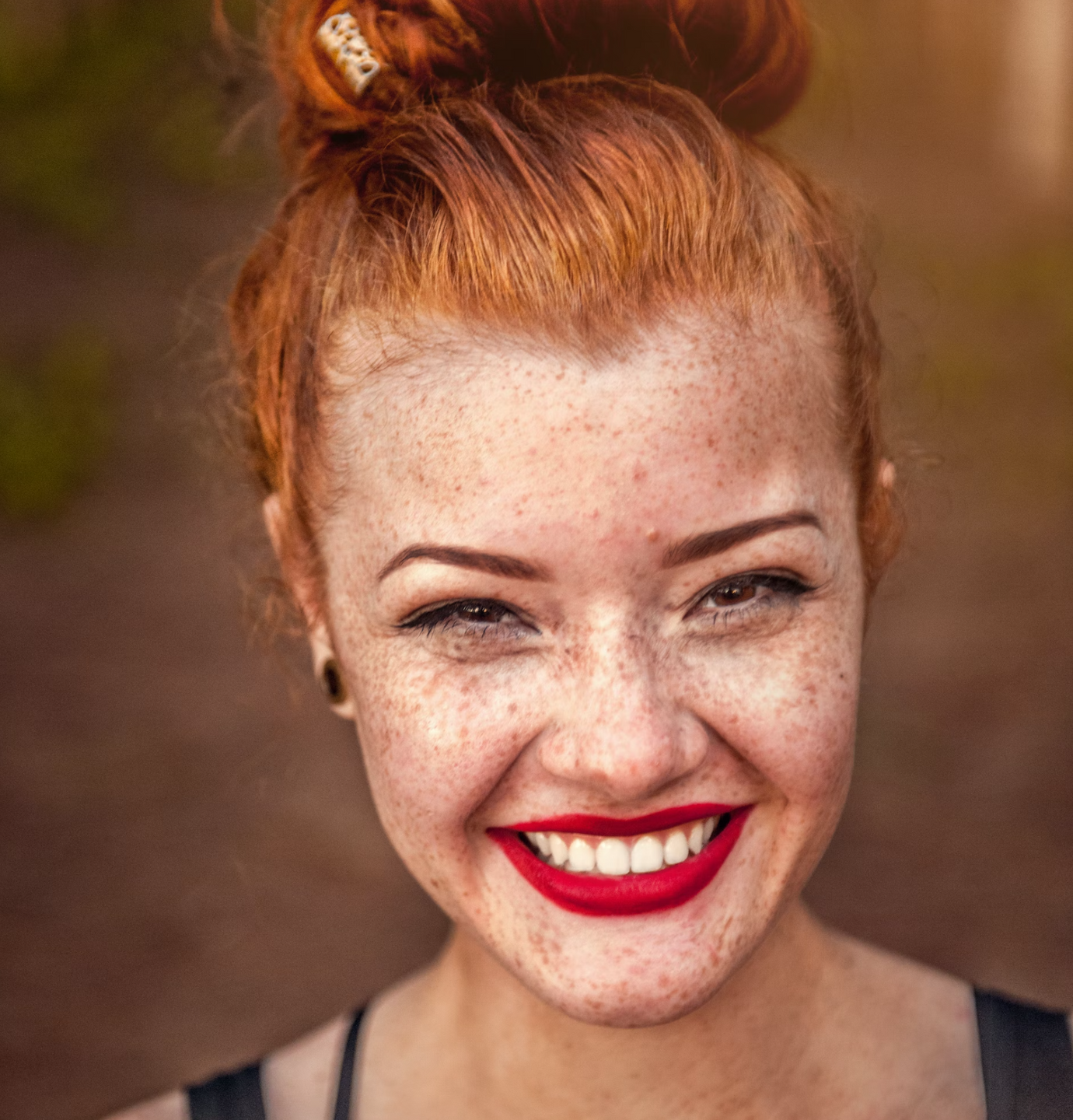 Portrait of a smiling red head girl with bright red lipstick