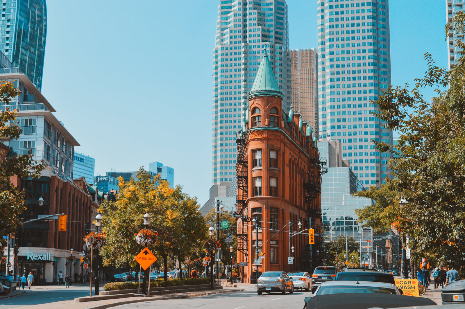 Streets of Toronto with tall skyscrapers and a red brick building